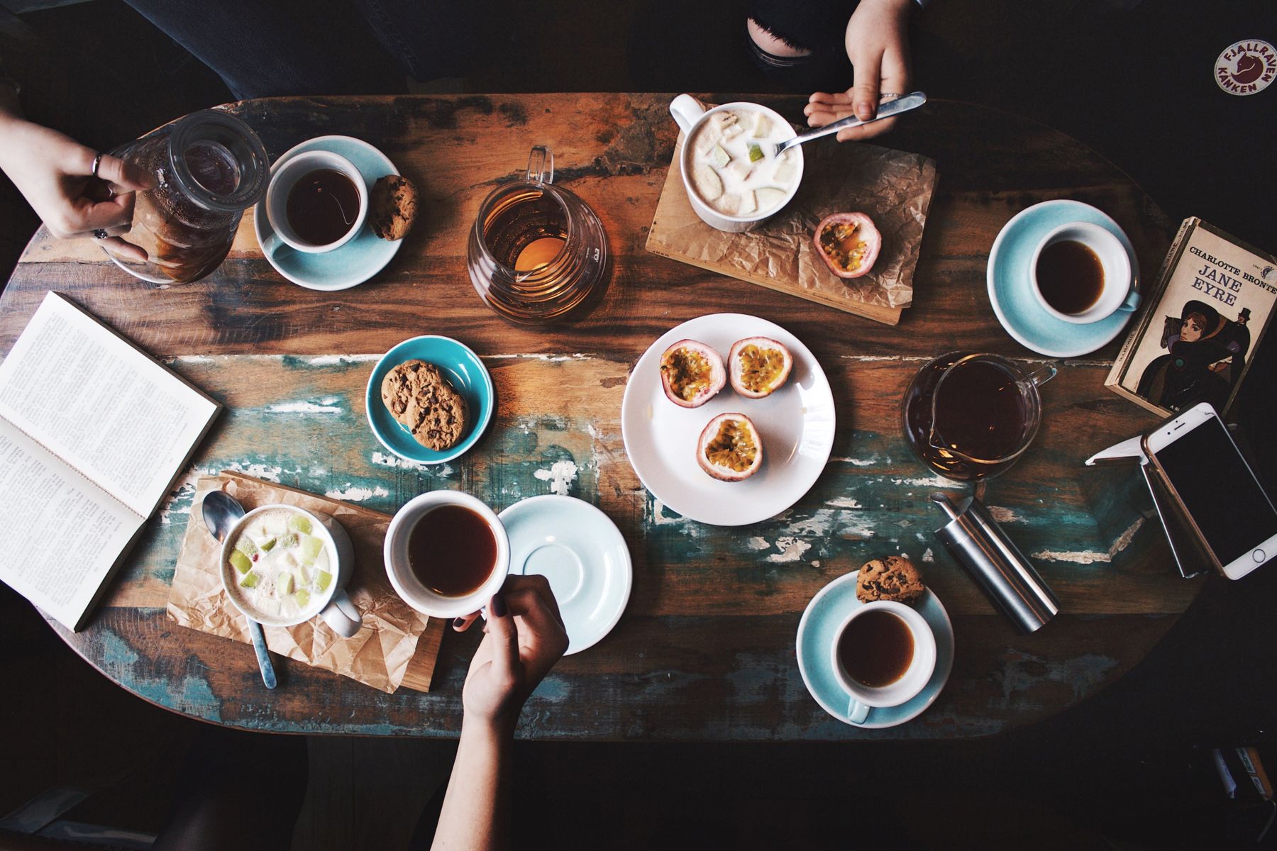Café table set with coffee cups and brunch plates viewed from above