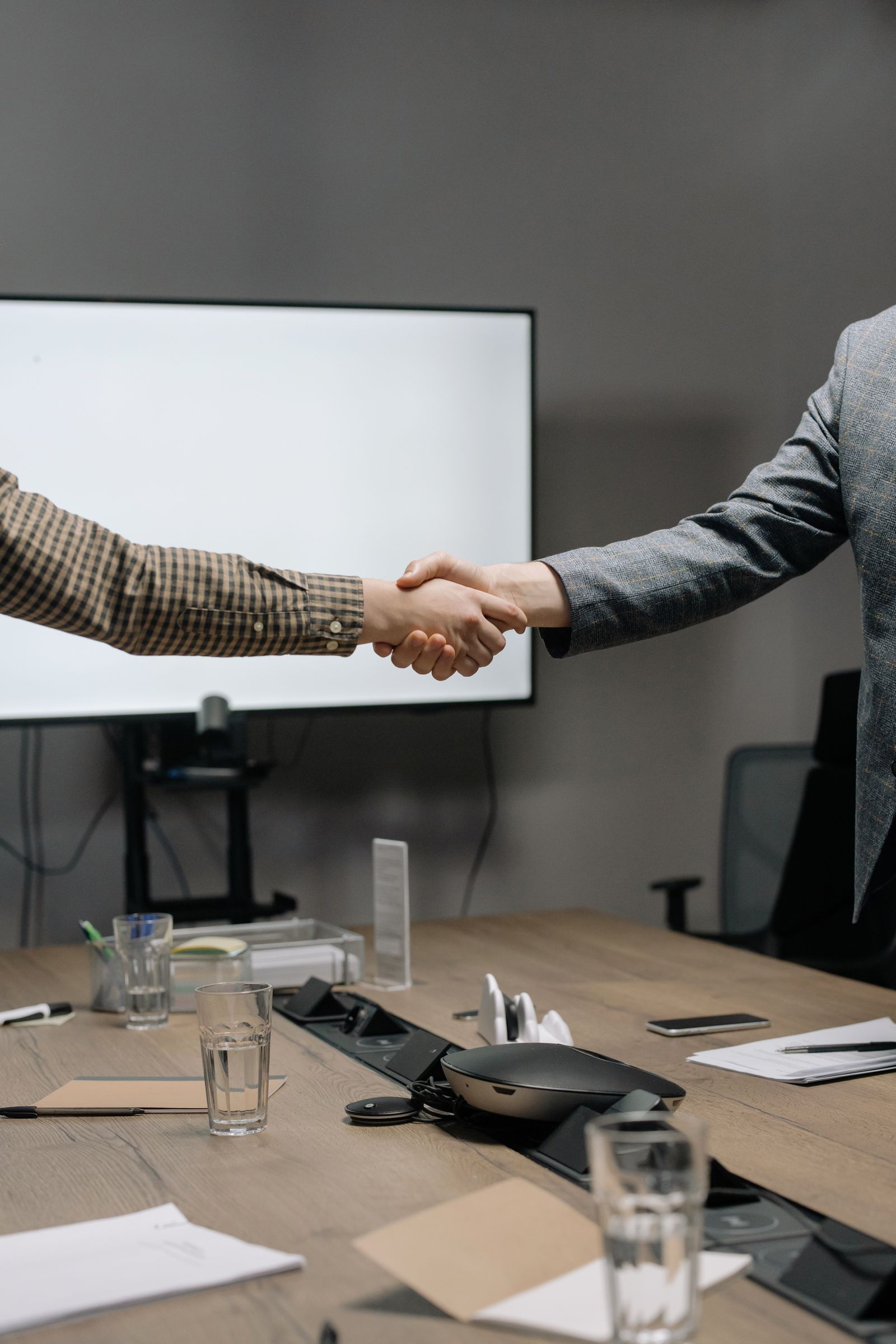 Consulting team in discussion around a table in a modern boardroom