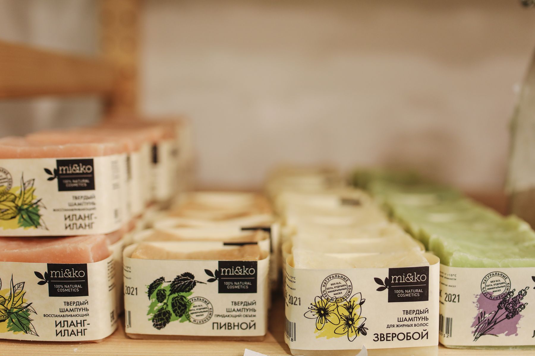 Rows of labelled glass jars holding dried herbs on a clinic dispensary shelf