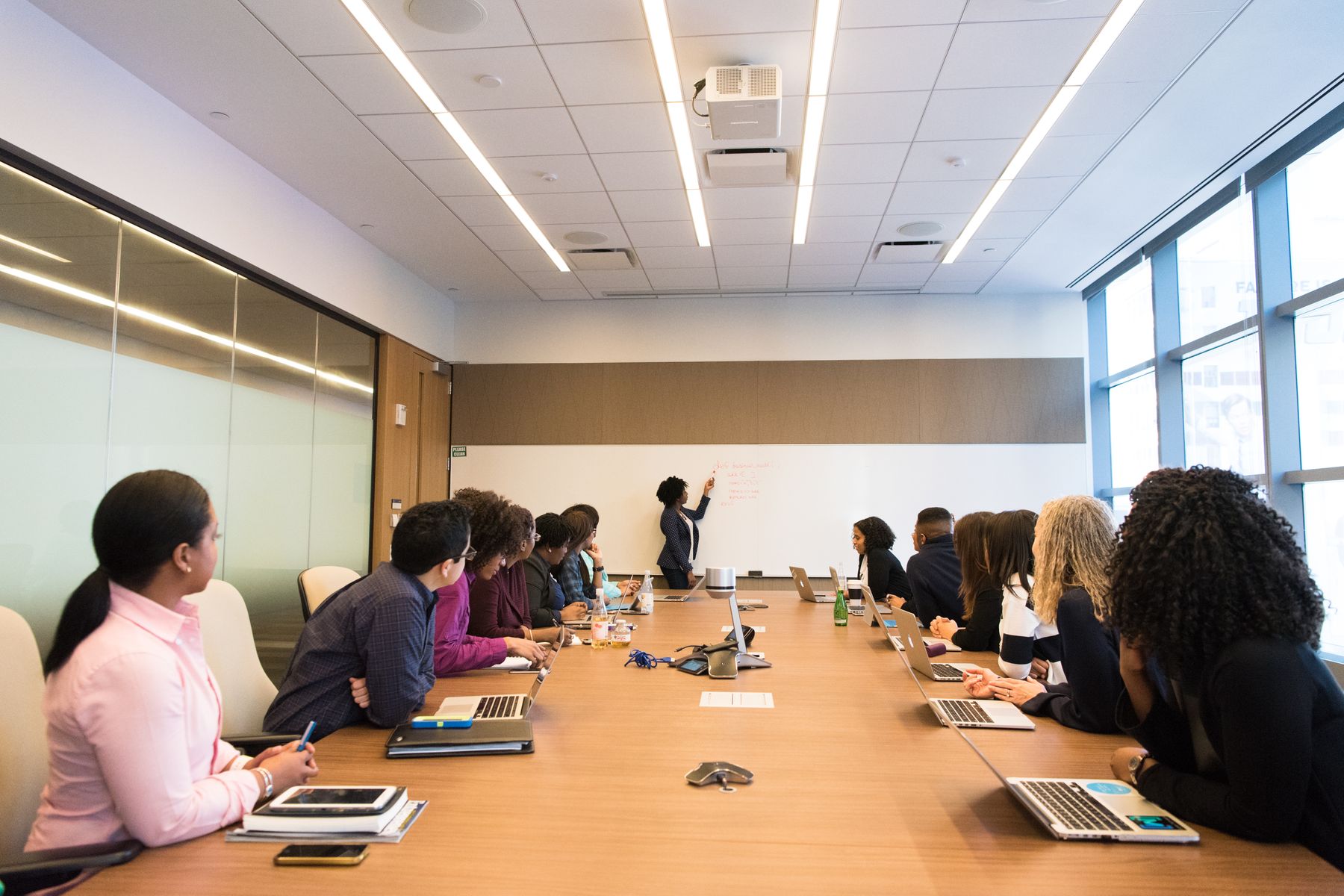 Team seated along a long boardroom table during a business meeting