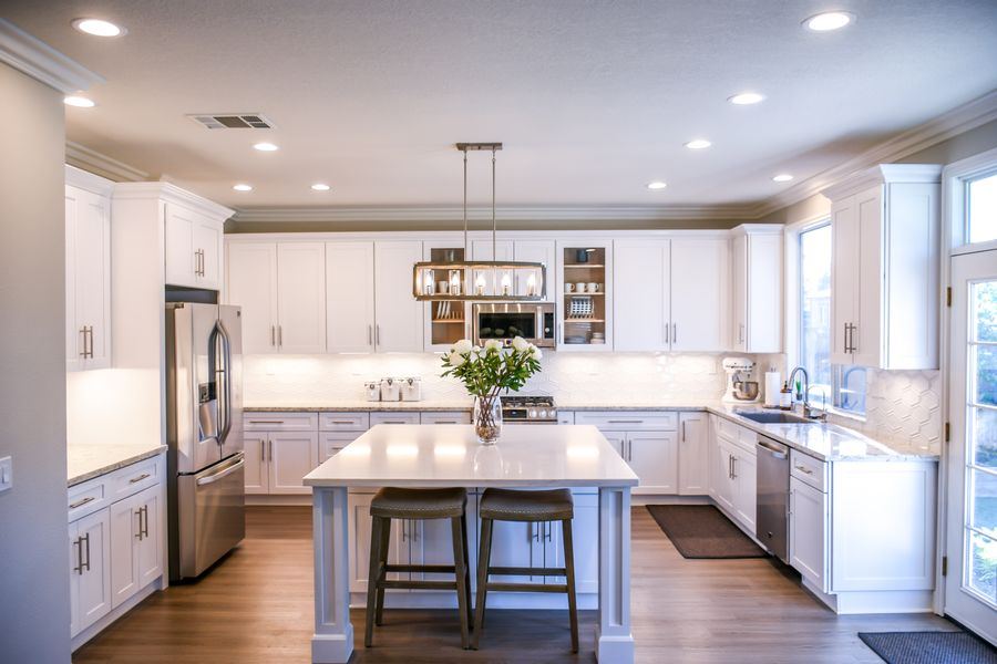 Renovated open-plan kitchen with island bench, used as the hero image of a demonstration home builder website