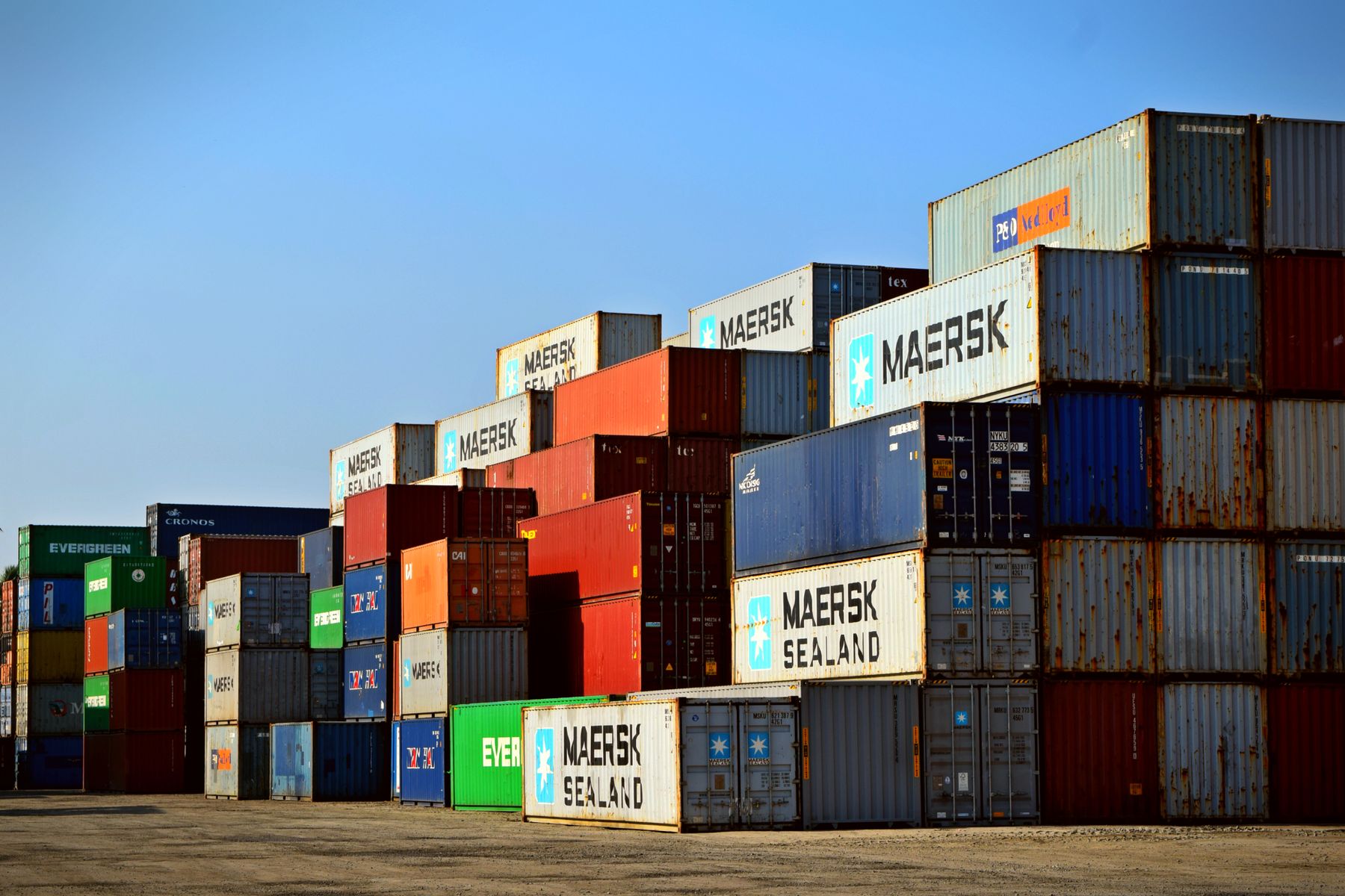 Stacked shipping containers waiting for collection at a freight yard