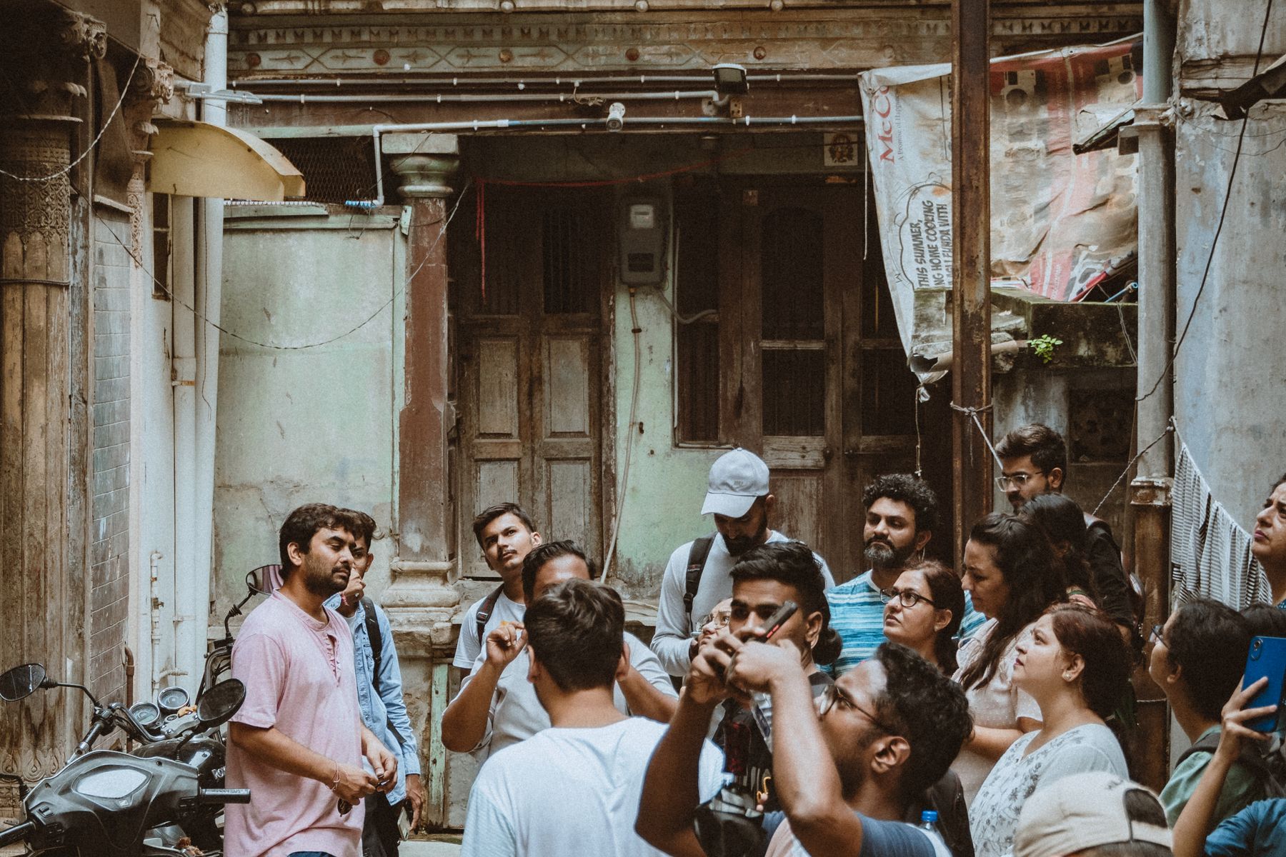 A guide talking to a group of visitors in a narrow old town street